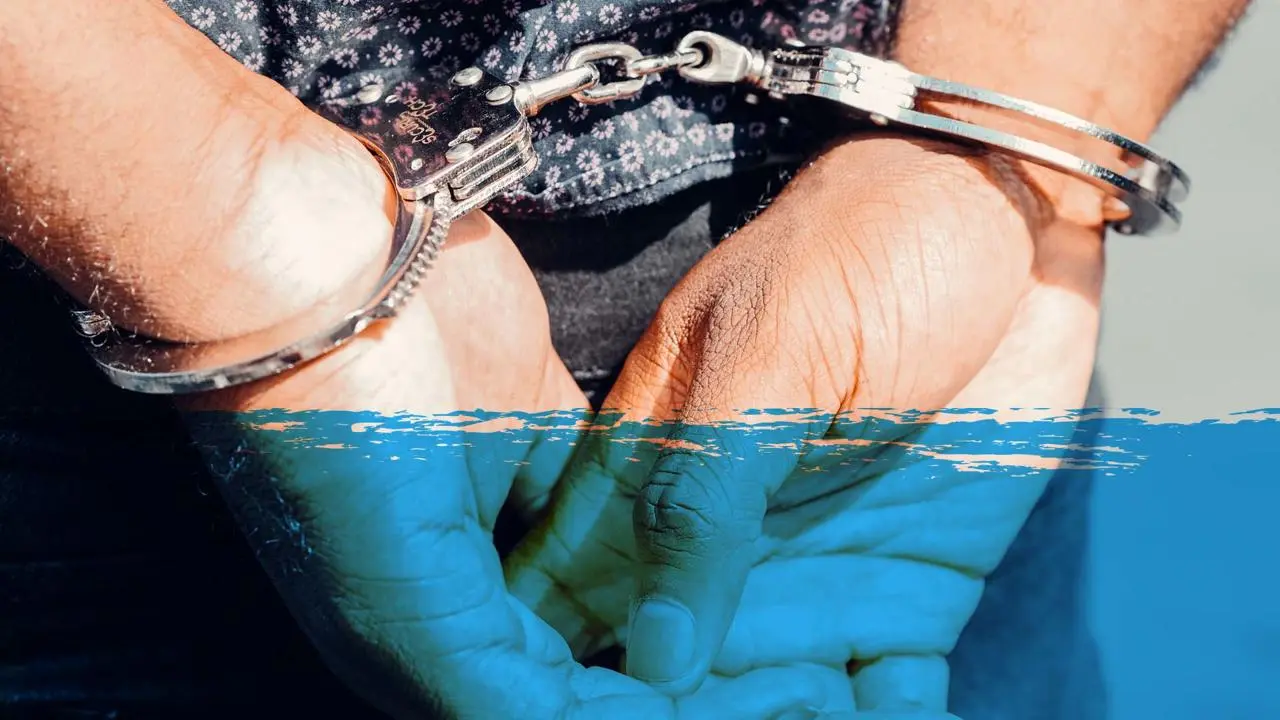 A pair of hands in handcuffs