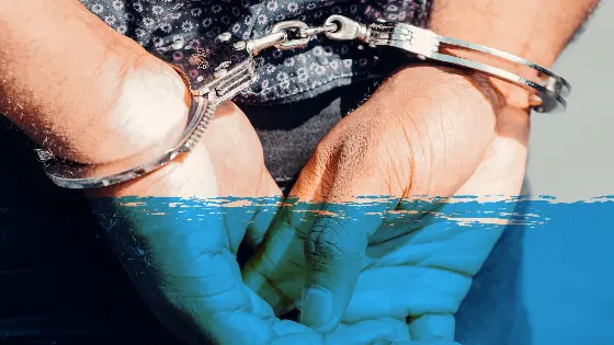 A pair of hands in handcuffs