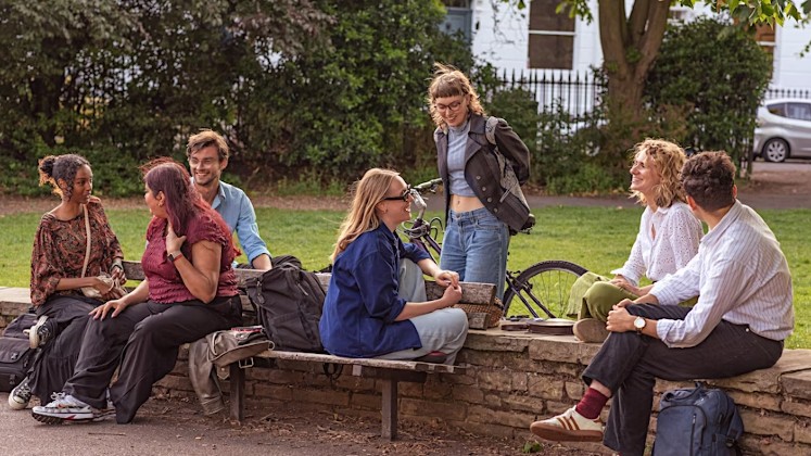 A group of people sitting in a park