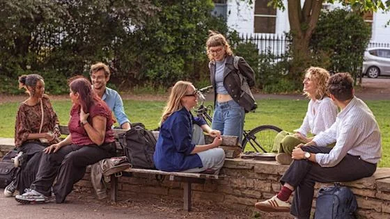A group of people sitting in a park
