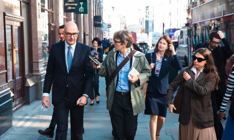 Professor Roland Lescure talking to journalist as he walks near LSE campus