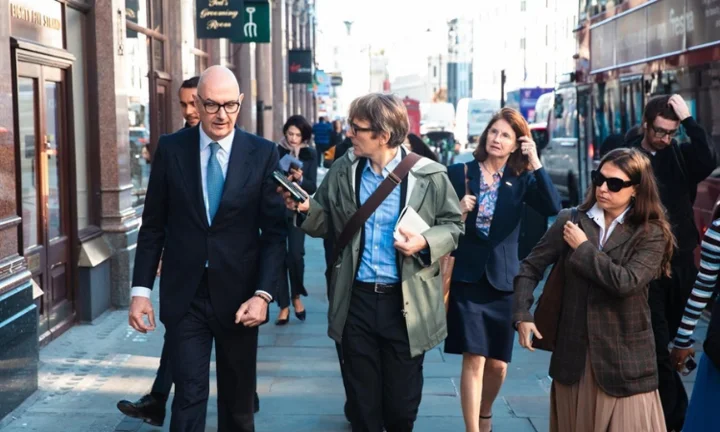 Professor Roland Lescure talking to journalist as he walks near LSE campus