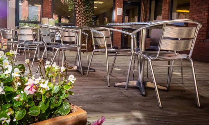 A communal garden with seating at a hall of residence