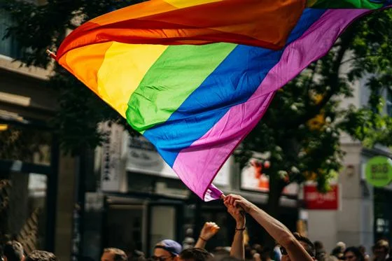 People waving rainbow flags
