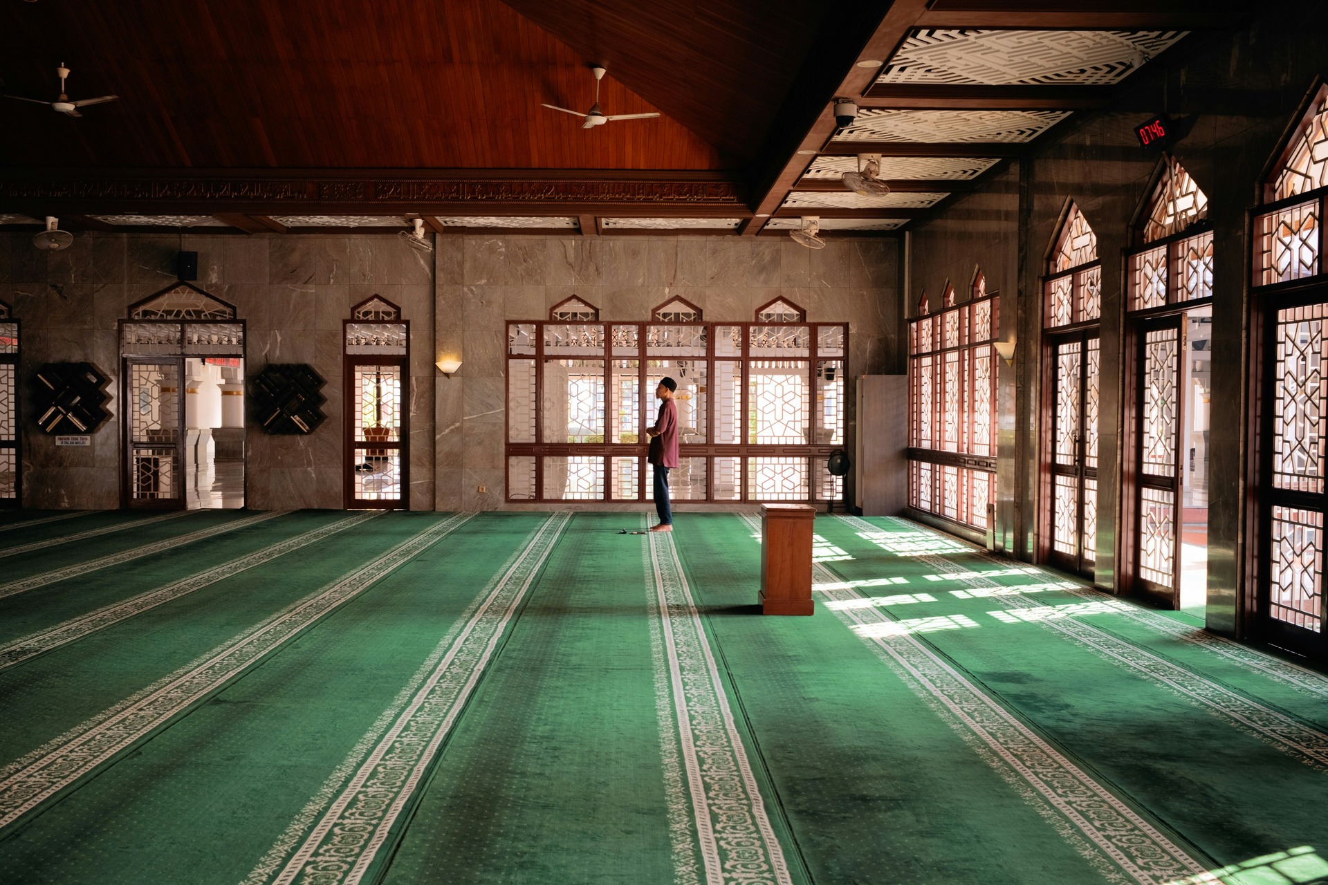 A man praying inside a mosque.