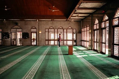 A man praying inside a mosque.