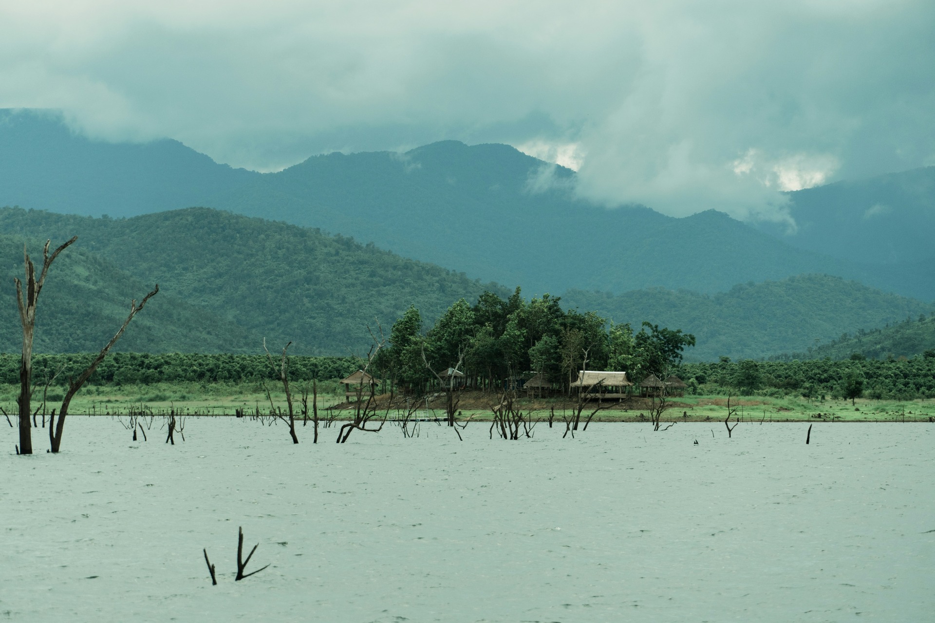 A flooded field with a view of a nearby mountain.