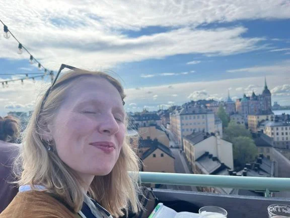 A photo of Ellie on a balcony overlooking Stockholm.