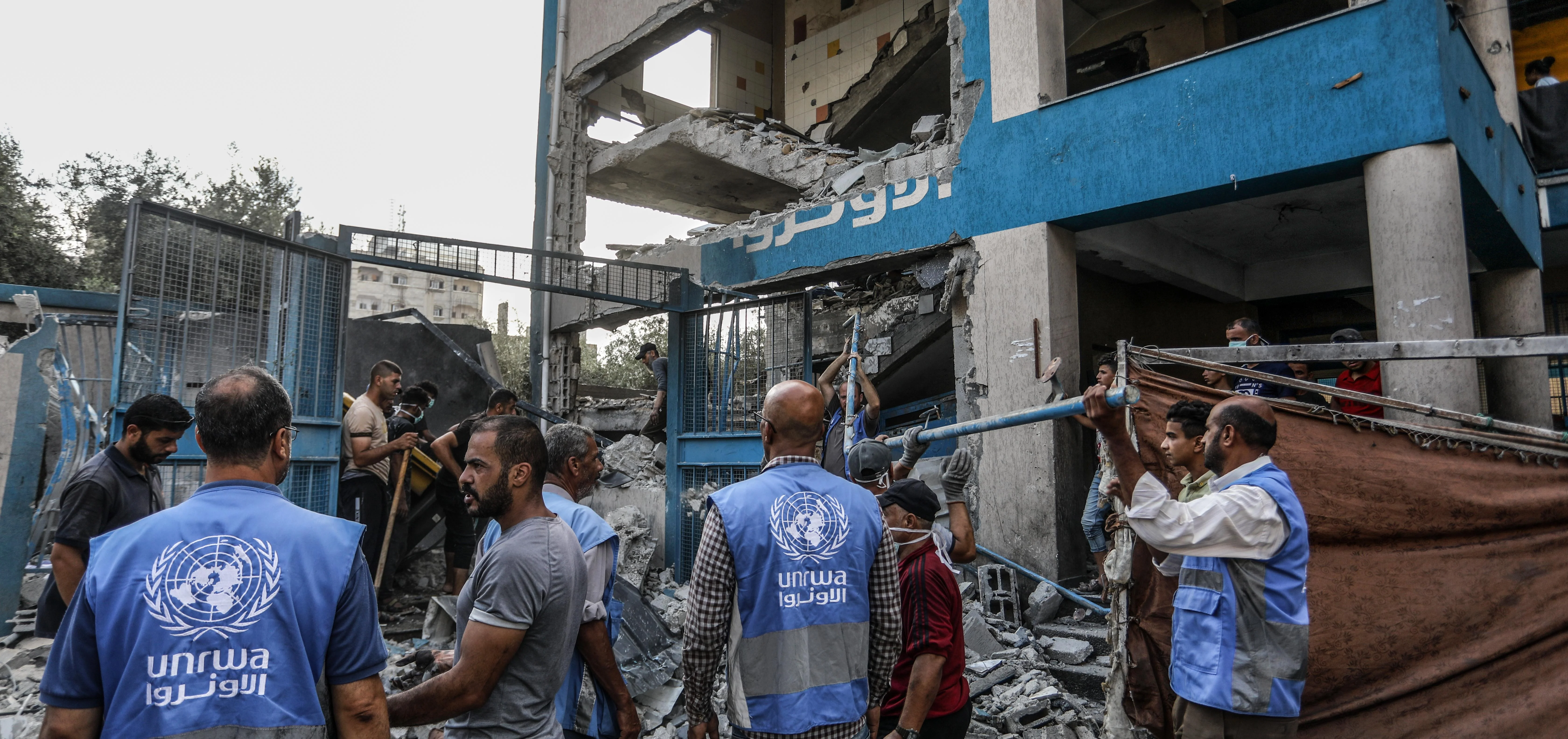 UNRWA staff clearing rubble.