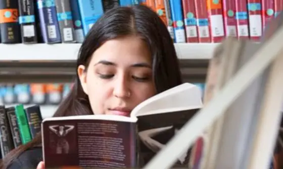 A girl reading in a library.