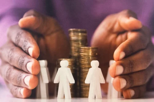 a pair of hands on either side of a pile of coins which is encircled by stick men figurines