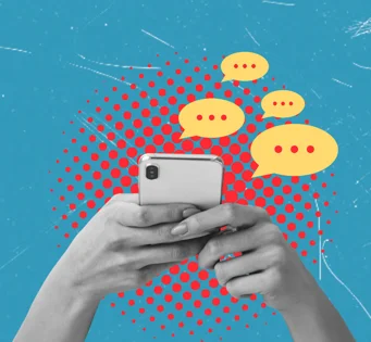 Hands typing on a mobile phone