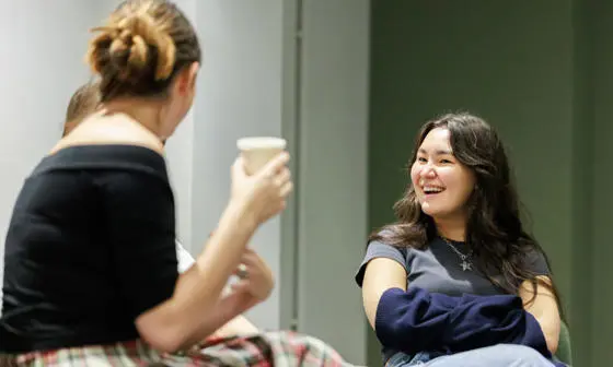 An image of two people talking whilst sitting down