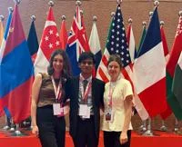 LSE students at a conference in front of international flags