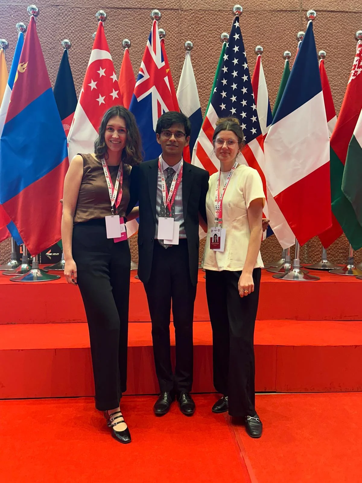 LSE students at a conference in front of international flags