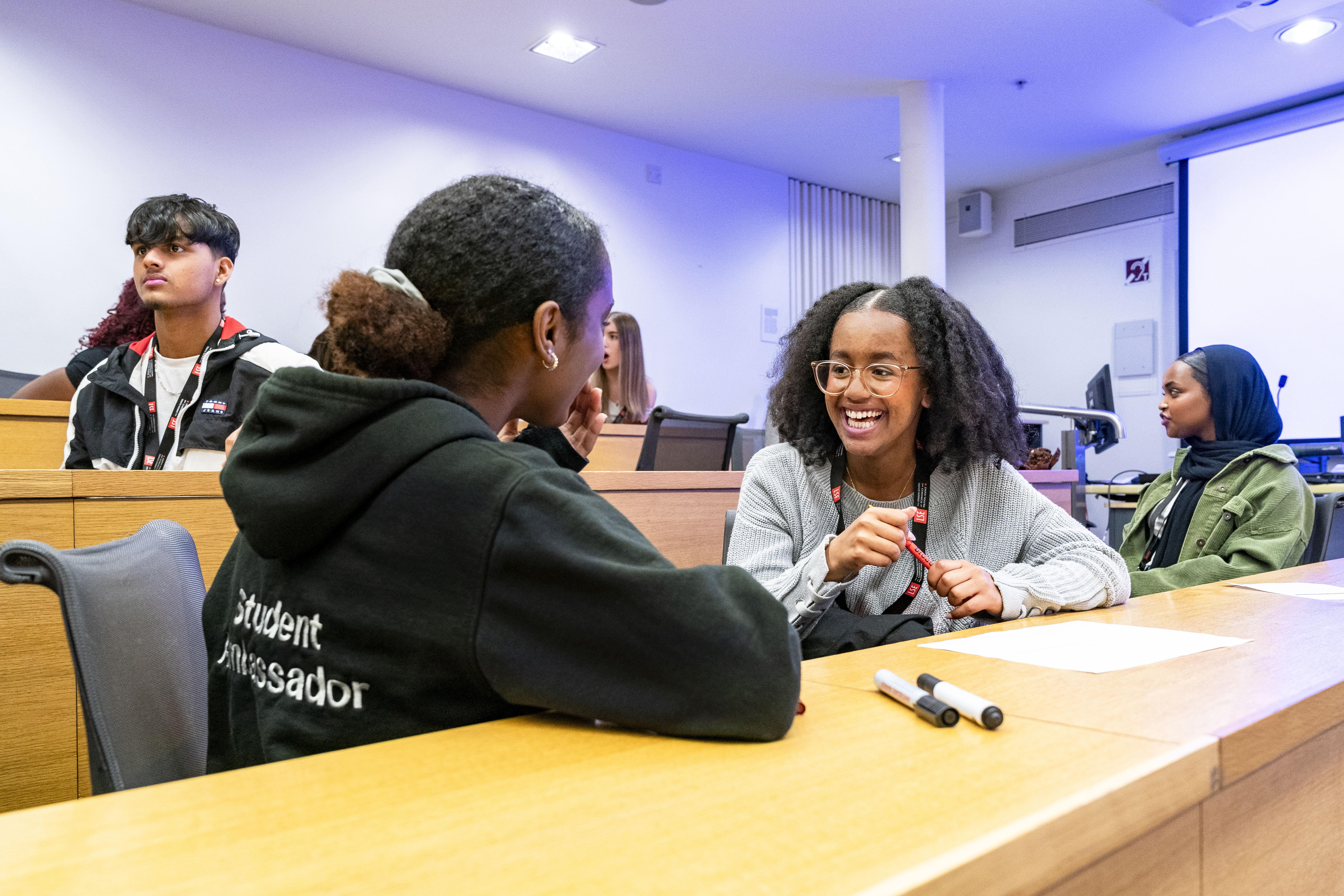 LSE Student Ambassador talking to a participant at a WP event