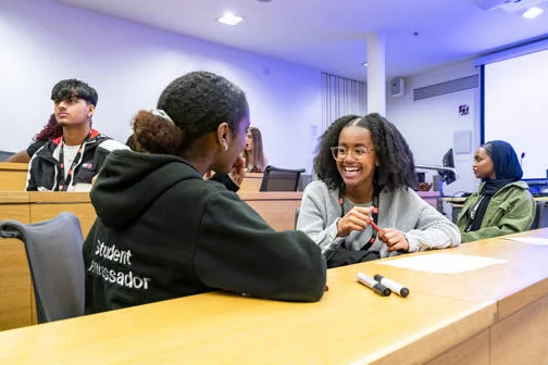 LSE Student Ambassador talking to a participant at a WP event