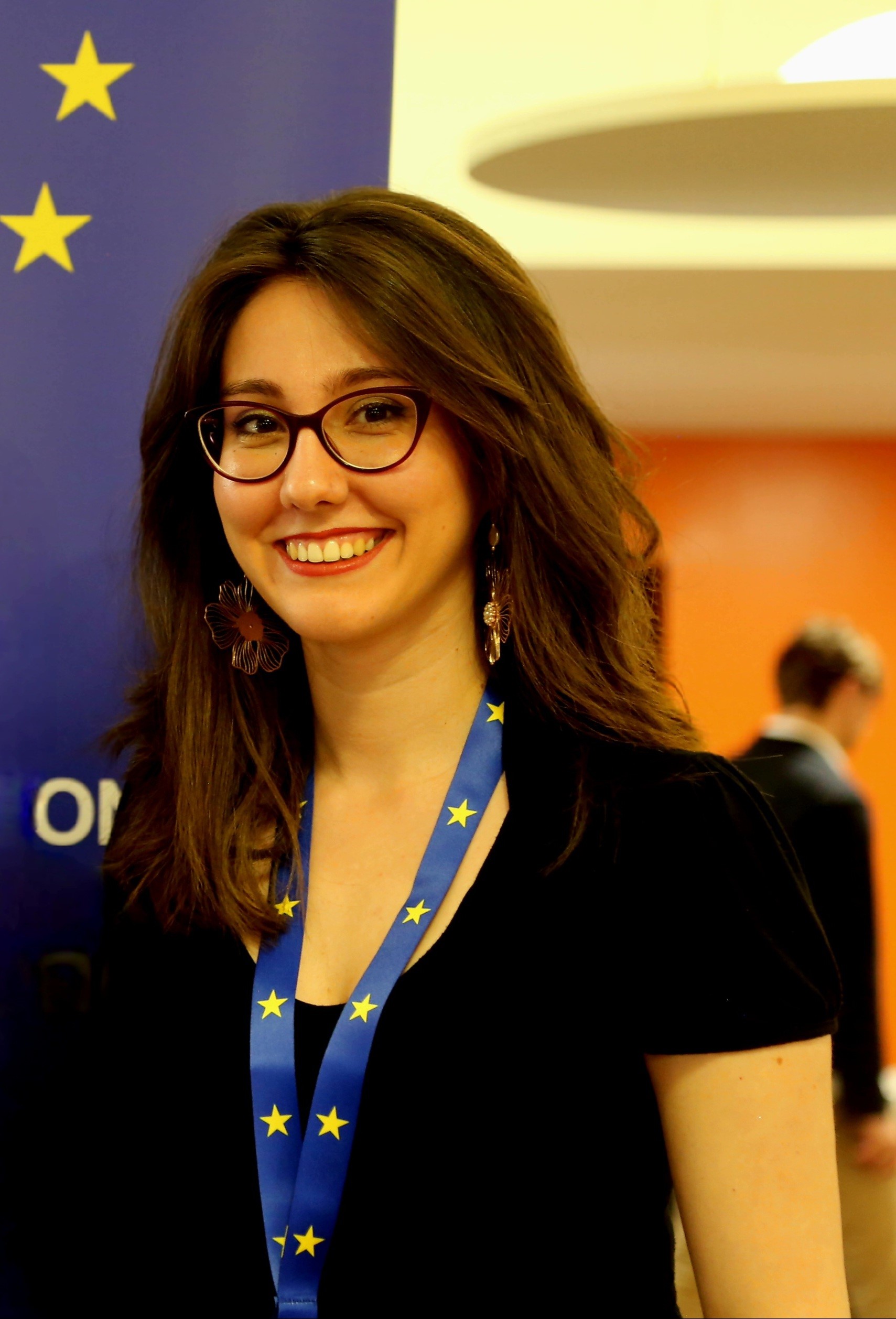 image of Stella Mavropoulou smiling with an EU flag lanyard
