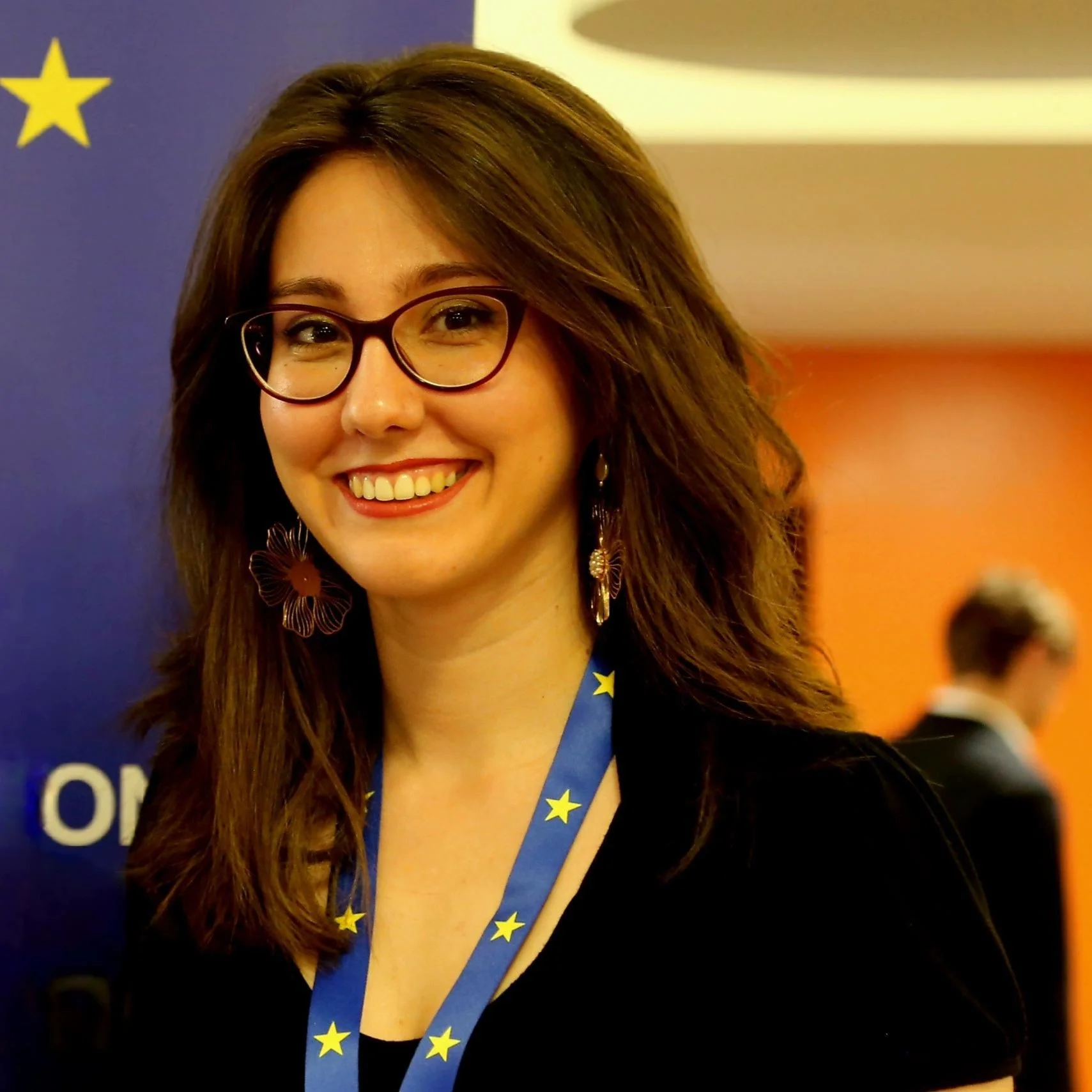 image of Stella Mavropoulou smiling with an EU flag lanyard