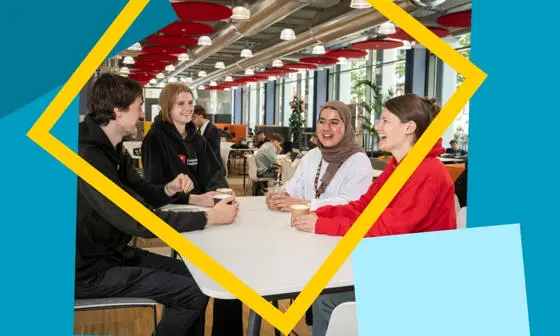 Four students smiling and chatting with coffee