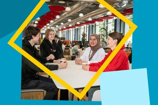 Four students smiling and chatting with coffee