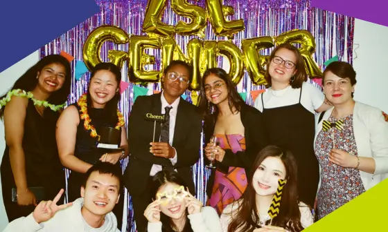 A group of students and faculty laughing at a ceebration