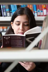A student reading a book in the Library.