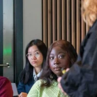 Students look at a teacher