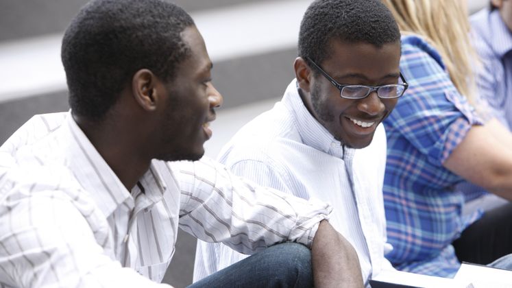Two male students talking to each other