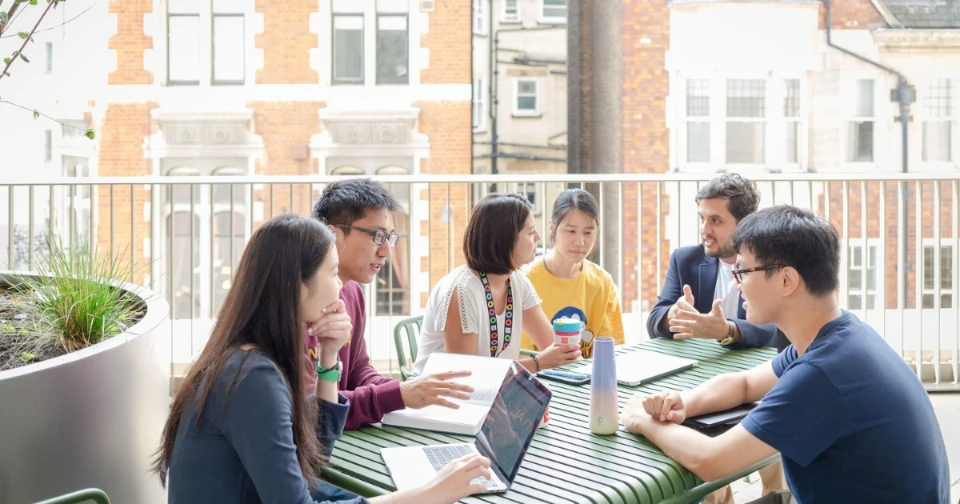 a group of students sitting around a table at LSE