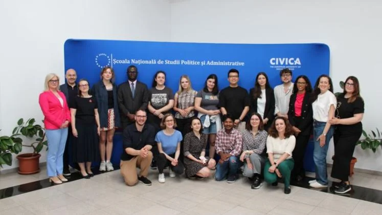 Participants and staff gathered for a CIVICA summer school group photo in front of a branded backdrop.
