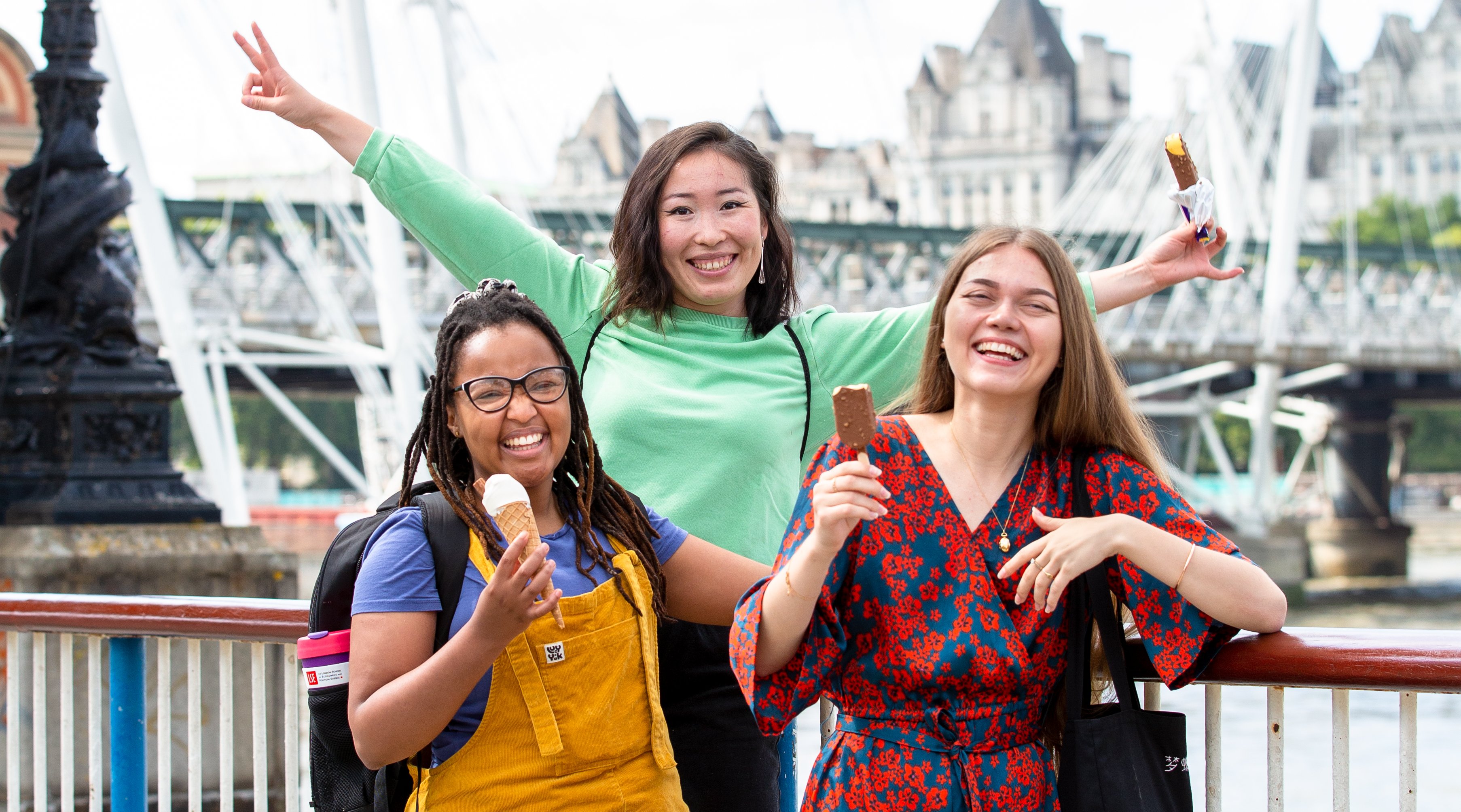 three students eating ice cream smiling