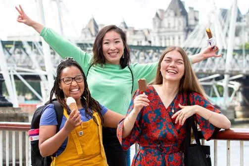 three students eating ice cream smiling