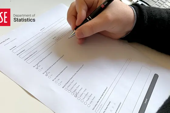 Person completing a paper survey form