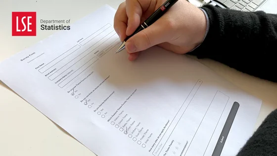 Person completing a paper survey form