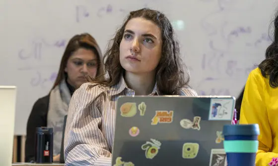 A European Institute student in class with a laptop