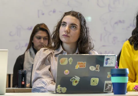 A European Institute student in class with a laptop