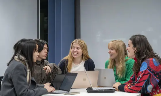 A group of students working together on laptops