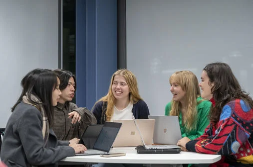 A group of students working together on laptops