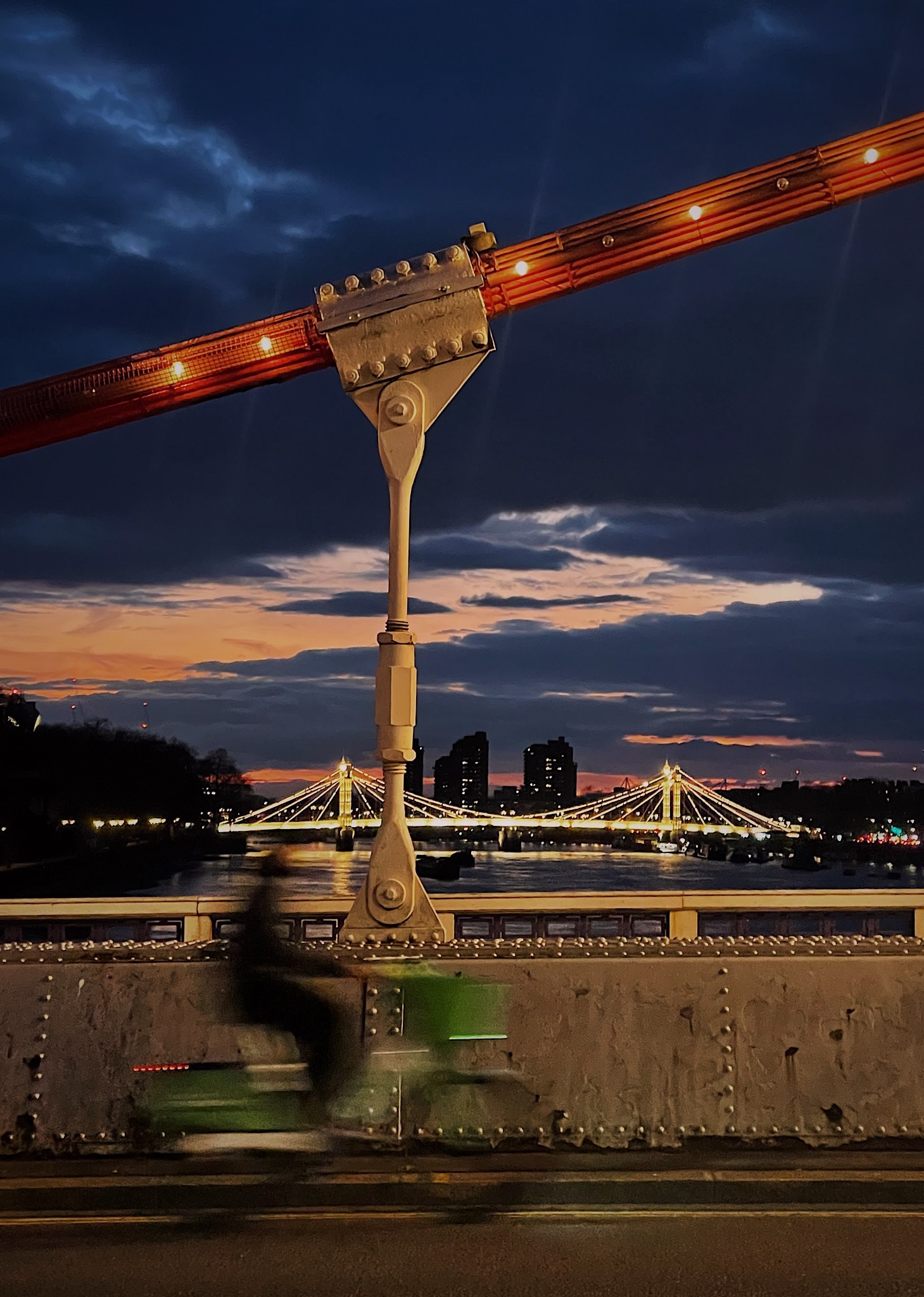 illuminated bridges and lime biker in motion