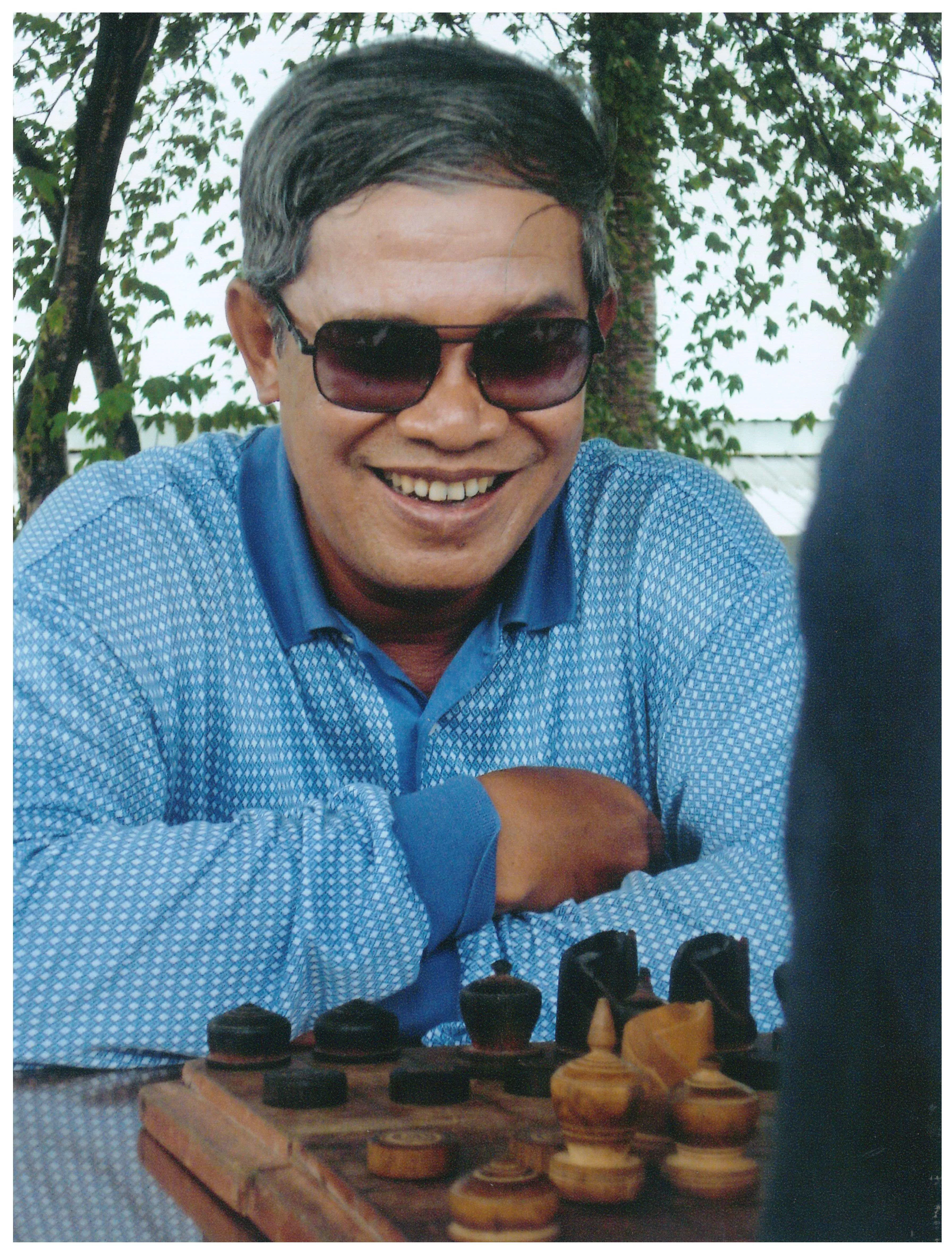 Hun Sen is sitting with a chessboard