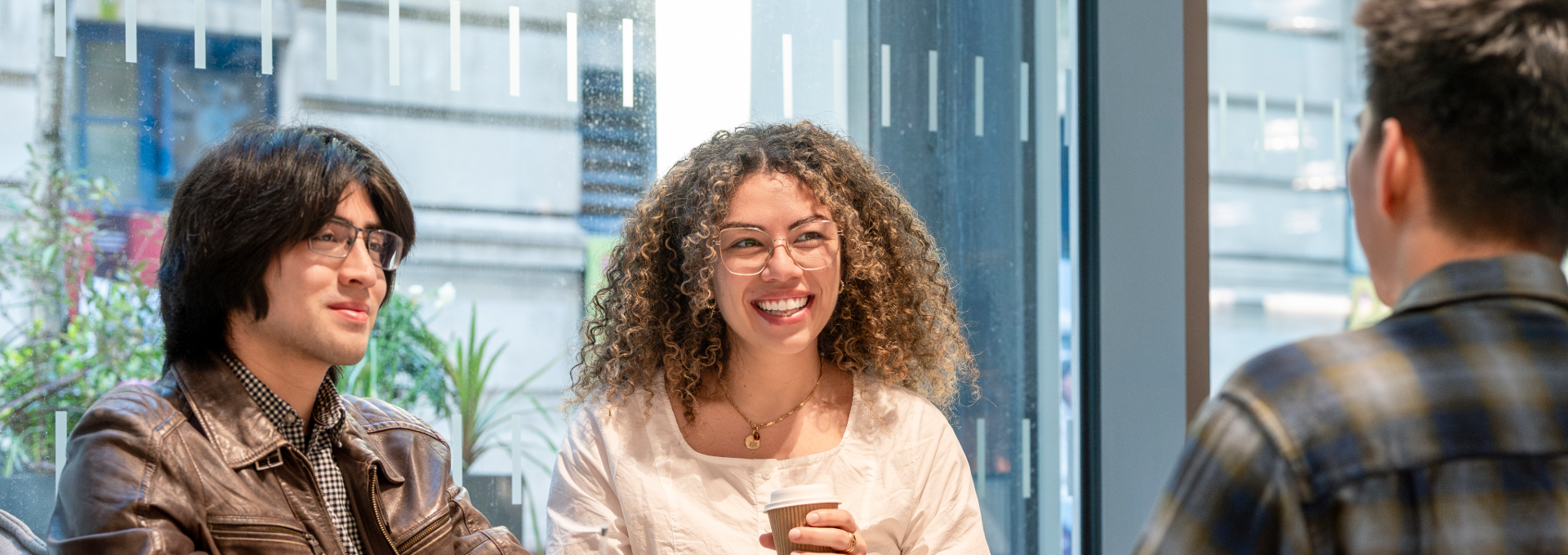 Three PBS students talking in the LSE Centre Building