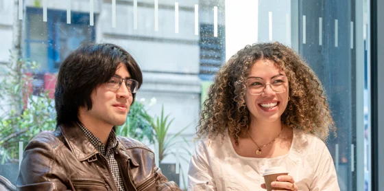 Three PBS students talking in the LSE Centre Building