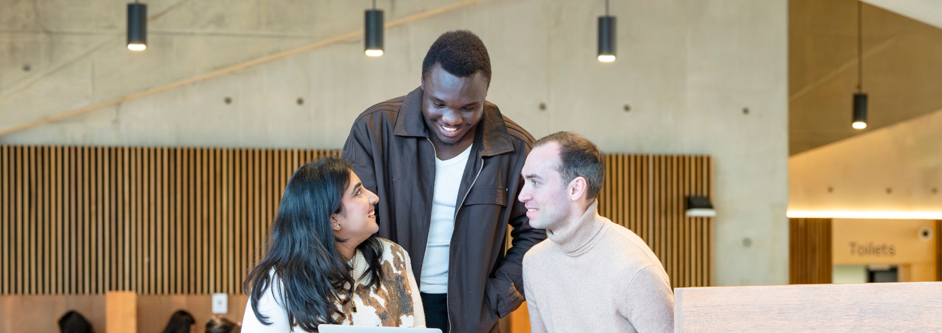 Three PBS students talking in the Marshall Building