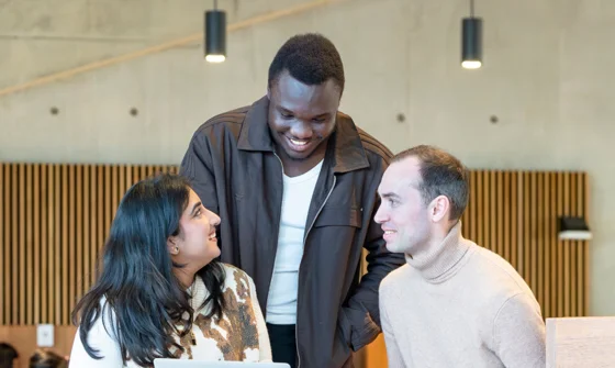 Three PBS students talking in the Marshall Building