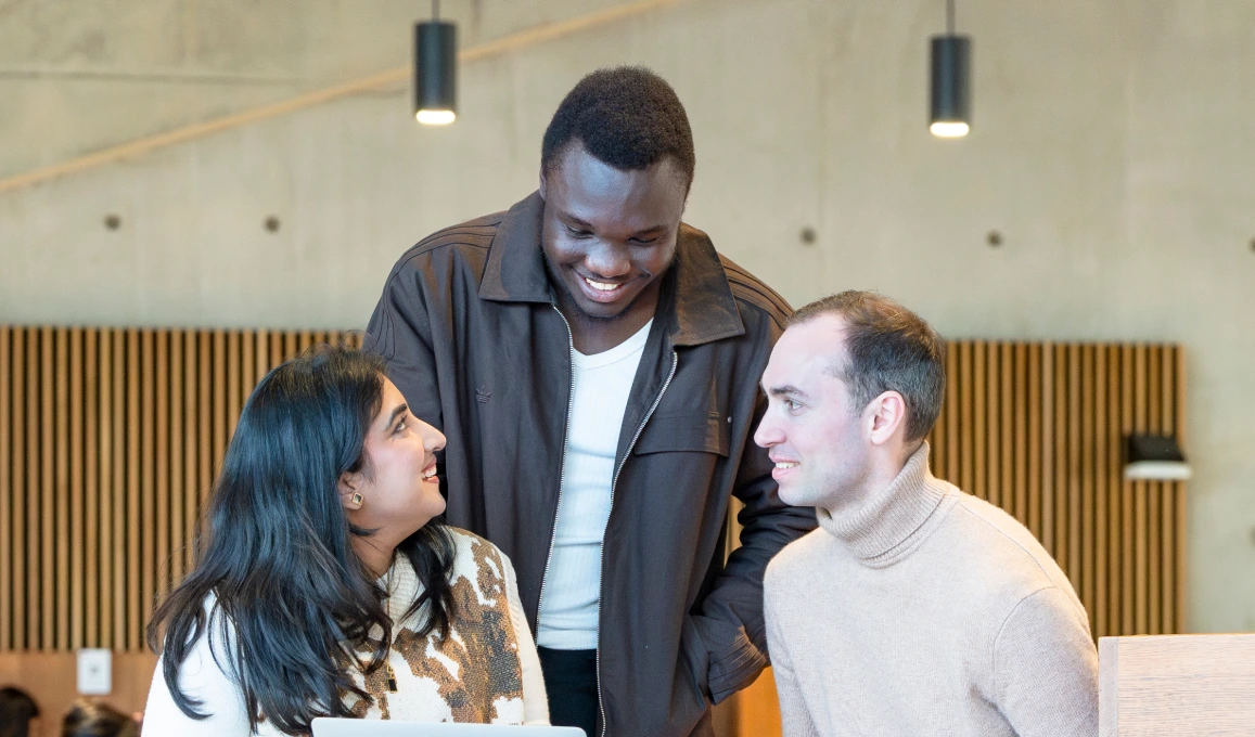 Three PBS students talking in the Marshall Building