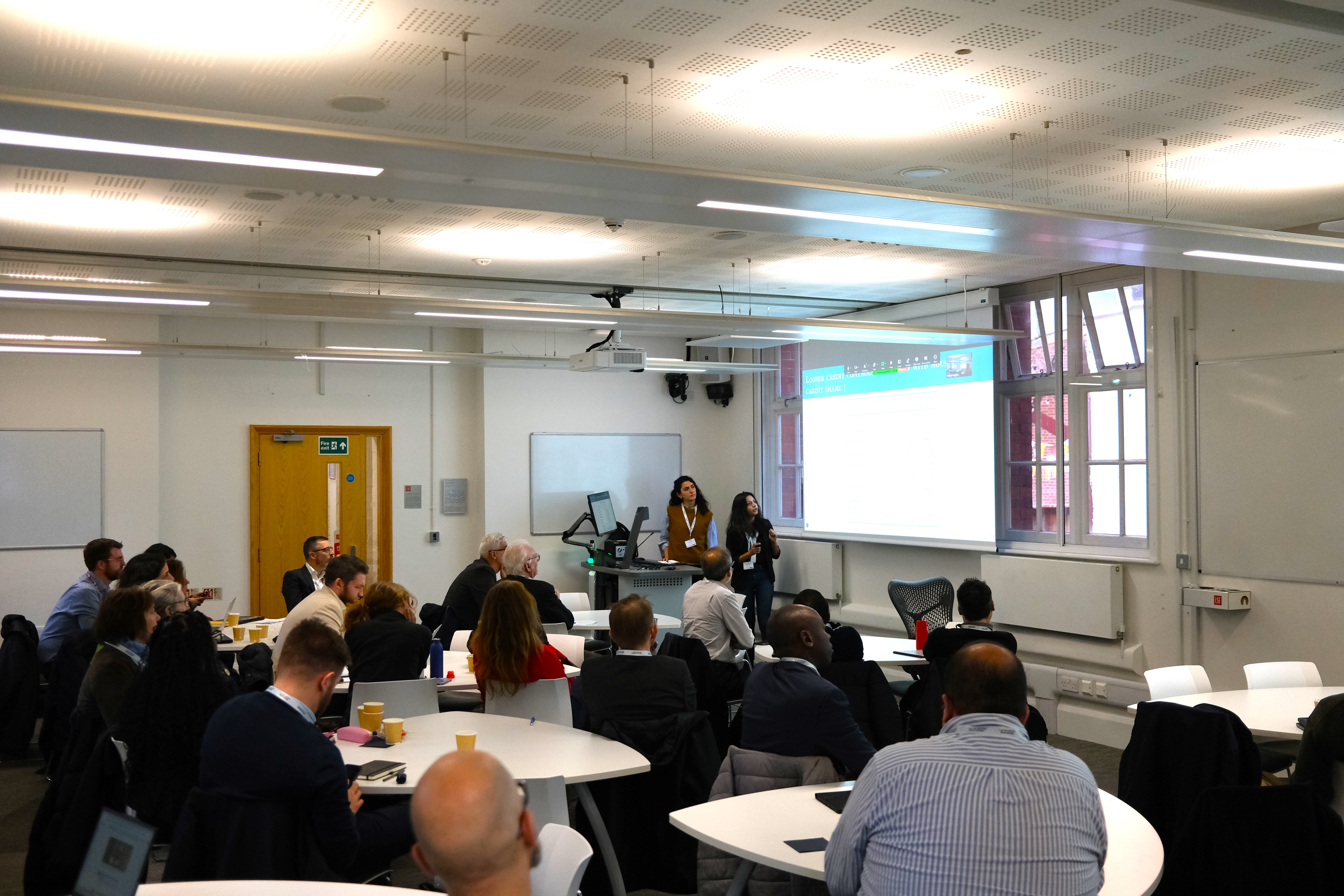 Attendees watching a conference presentation