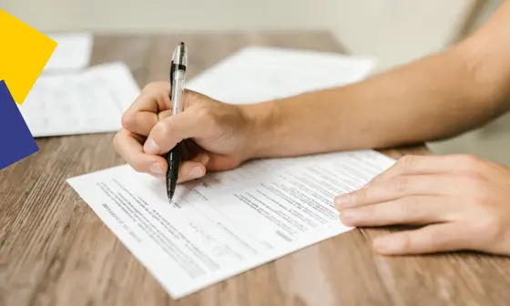 A person completes a written form