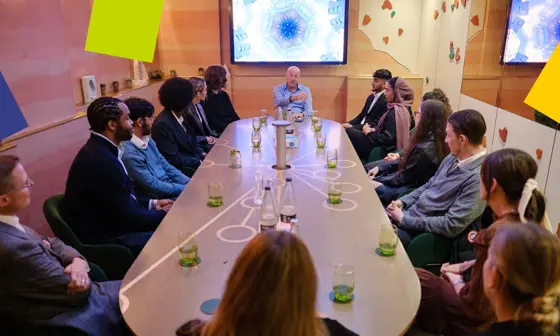 Uggla Family Scholars sit around a table