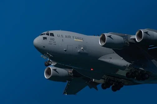 A US air force cargo plane against a blue sky background